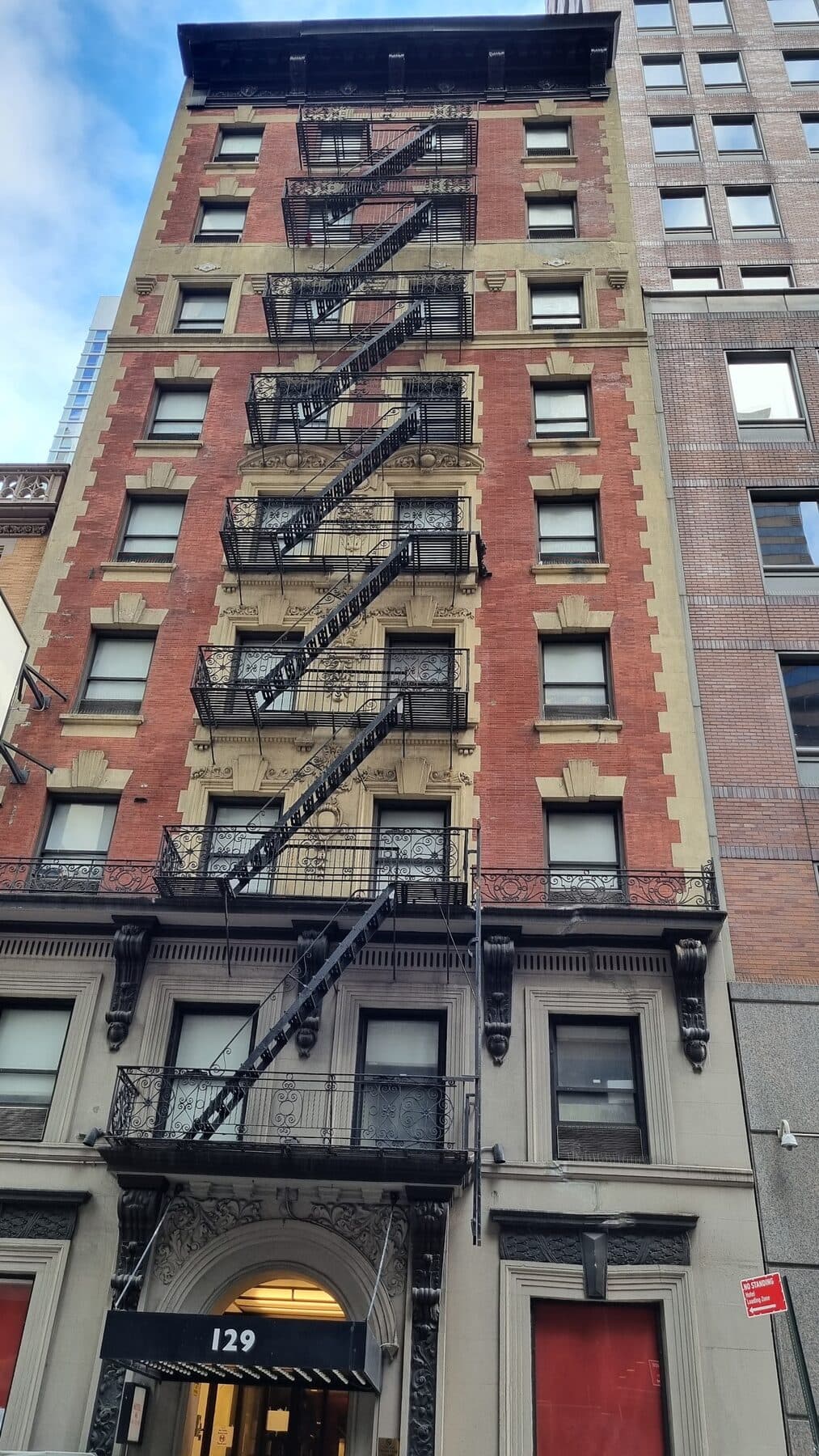 The brick facade of 129 West 46th Street