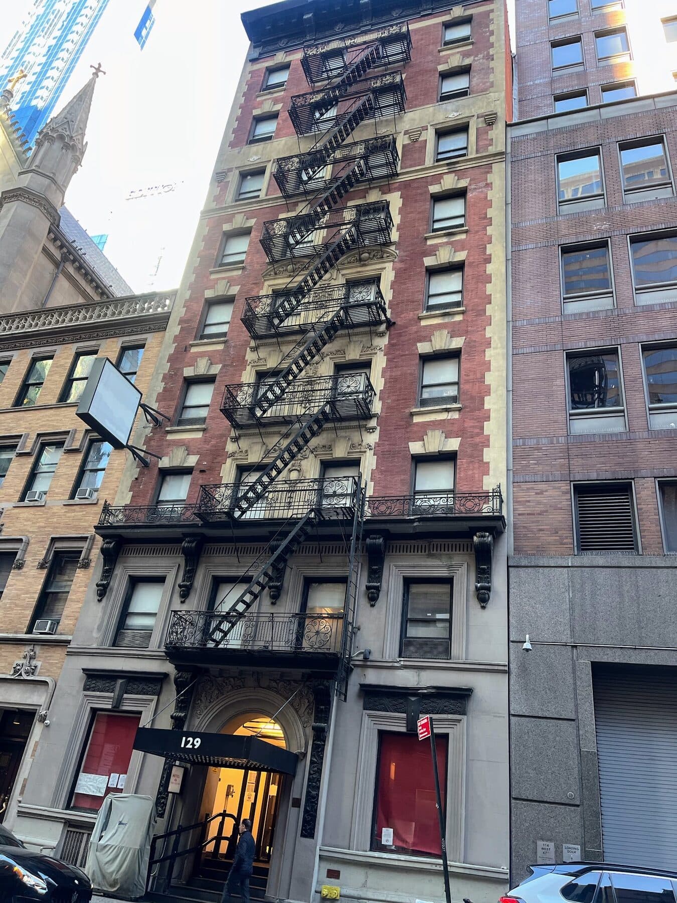 Looking up the facade of 129 West 46th Street