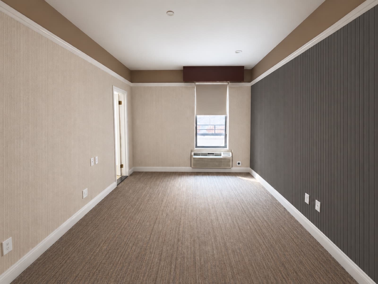 The empty room, facing the window with the slatted accent wall at The 46, 129 West 46th Street, Midtown NYC
