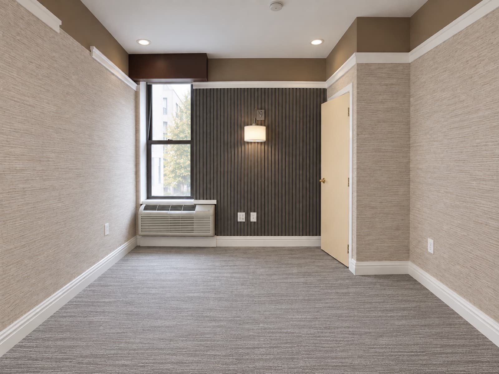 The empty room, facing the window and slatted accent wall at The 46, 129 West 46th Street, Midtown NYC