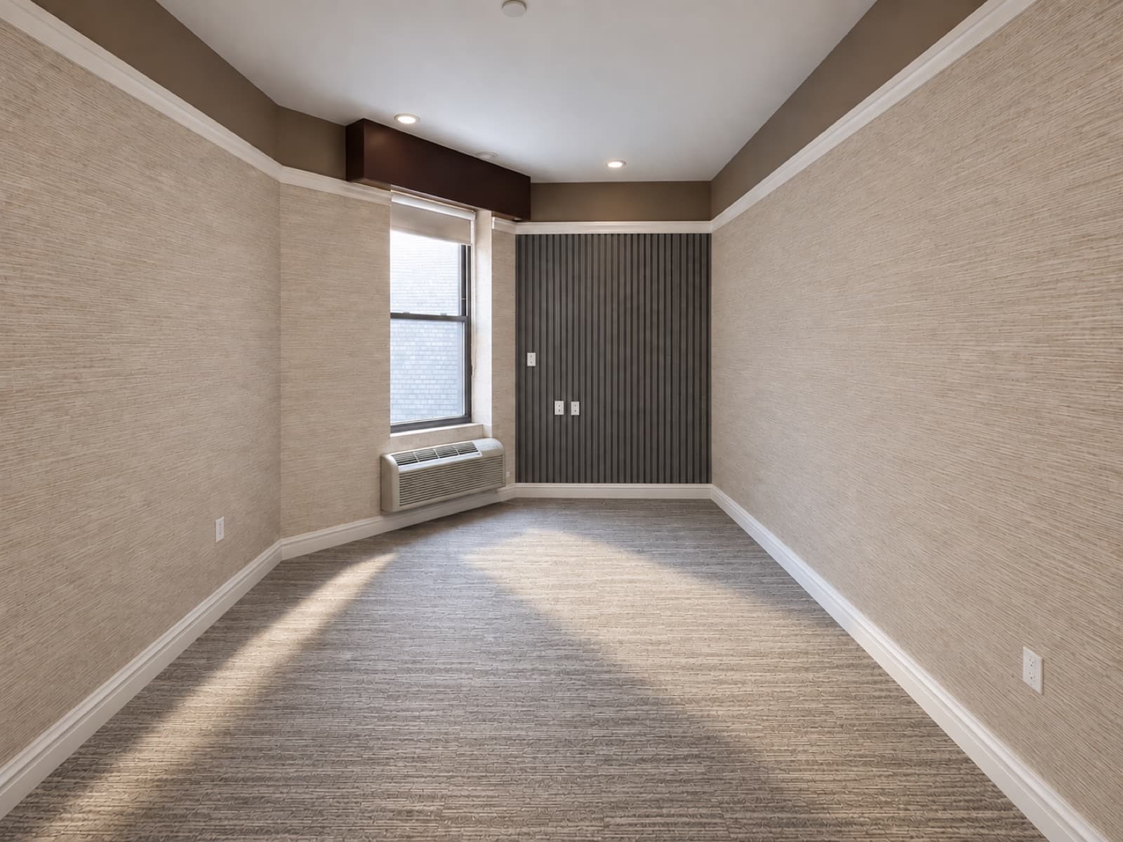The empty room, facing the window and slatted accent wall at The 46, 129 West 46th Street, Midtown NYC