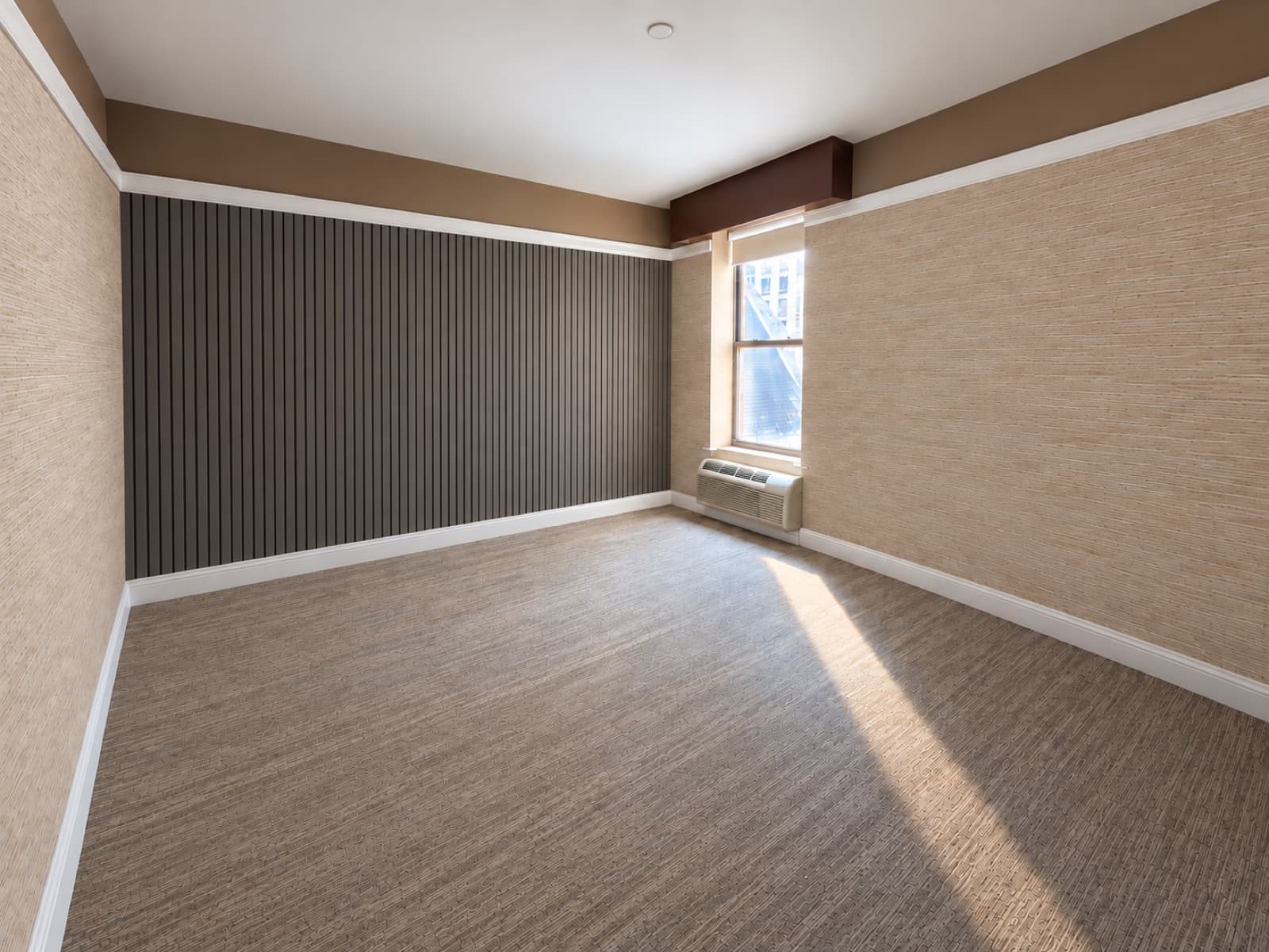 The empty room, facing the slatted accent wall and window at The 46, 129 West 46th Street, Midtown NYC