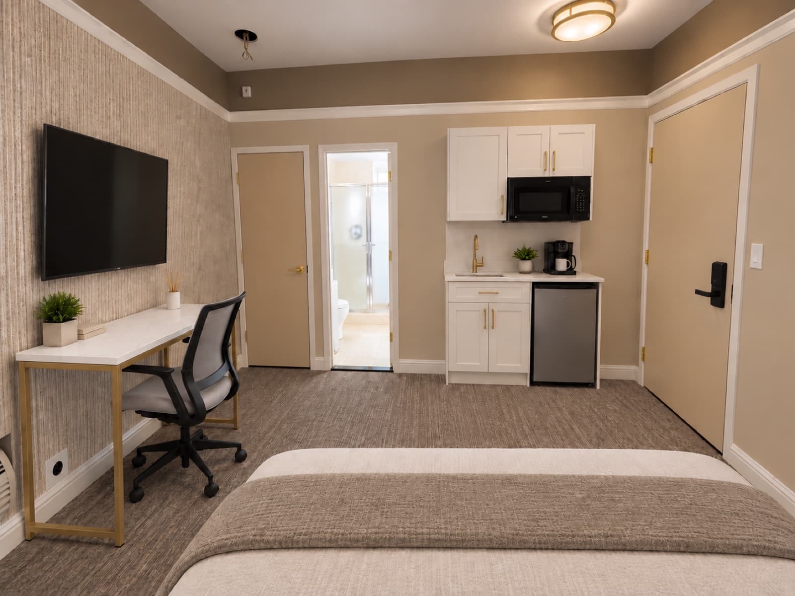 Virtually staged view of the desk and kitchenette area at The 46, 129 West 46th Street, Midtown NYC