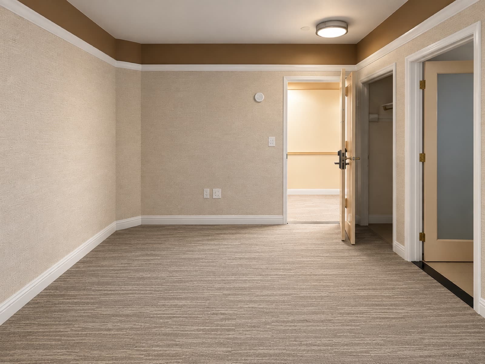 The empty room, looking toward the entry and closet doors at The 46, 129 West 46th Street, Midtown NYC