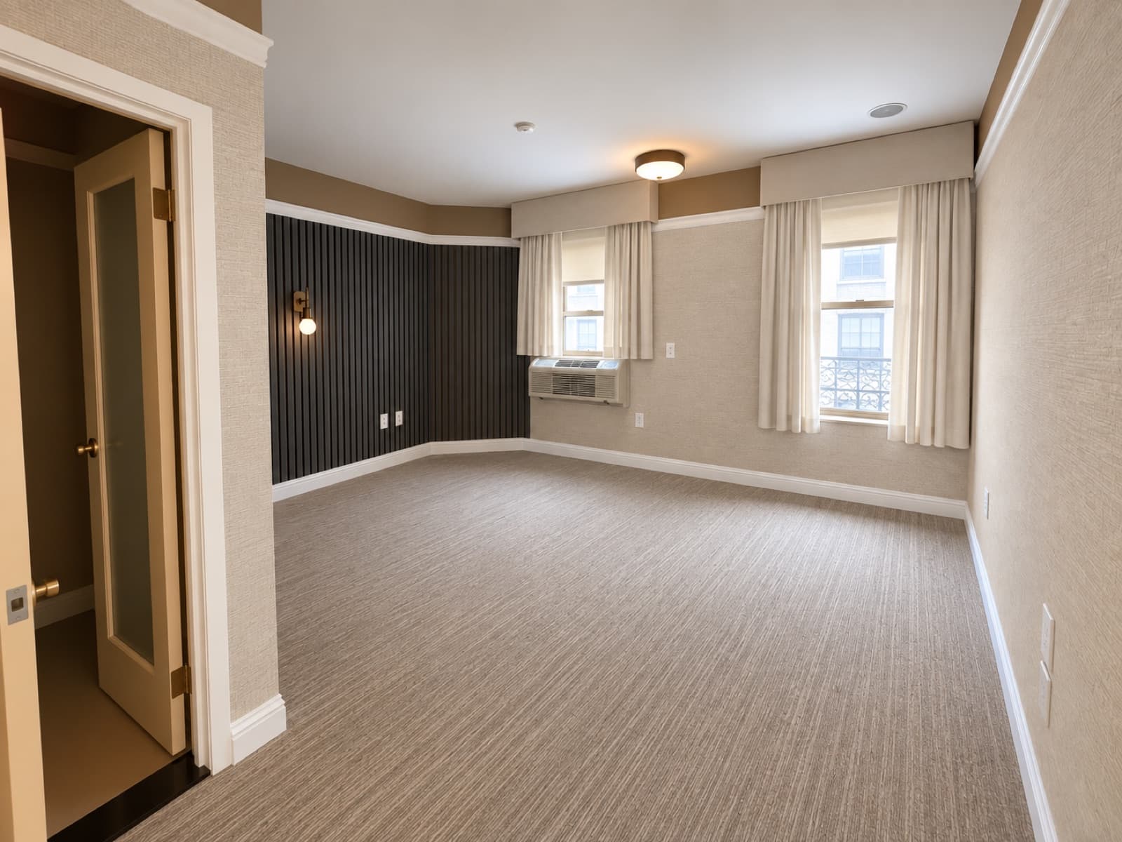 The empty room, window side with the slatted accent wall at The 46, 129 West 46th Street, Midtown NYC
