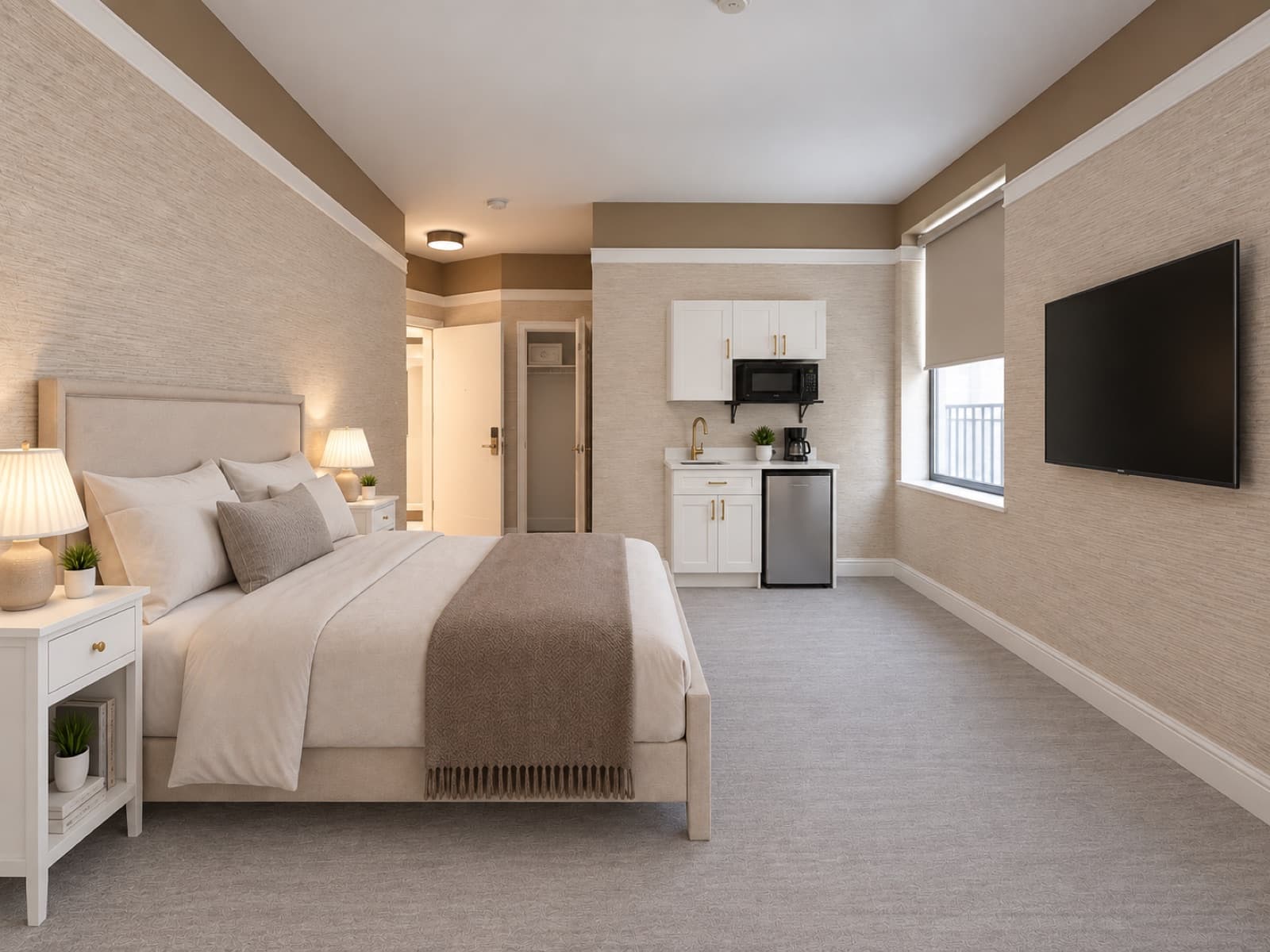 Virtually staged room with bed, wall-mounted TV and kitchenette area at The 46, 129 West 46th Street, Midtown NYC