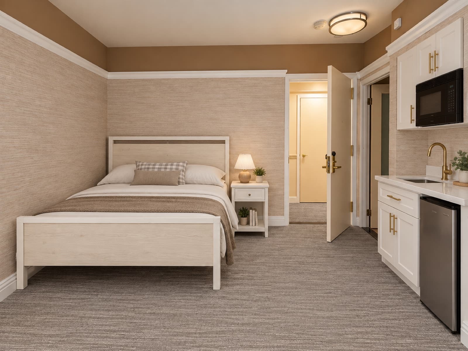 Virtually staged view of the bed and kitchenette area near the entry at The 46, 129 West 46th Street, Midtown NYC